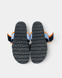 Black sandals with a blue and orange strap