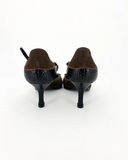 Brown and black pumps with a bow