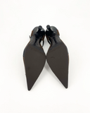 Brown and black pumps with a bow