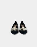 Black shoes adorned with pearls