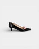 Black pumps with a pink bow