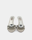 White heeled mules adorned with crystals