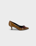 Brown patent leather pumps with burgundy bow
