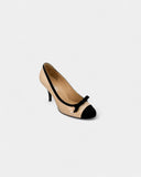 Beige leather and black fabric pumps